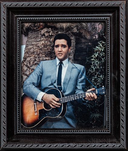 Autographed Photo of Elvis Presley, signed faintly in blue ball-point pen on the guitar.