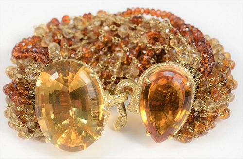 18 Karat gold and beaded bracelet
with clasp mounted with large oval citrines, surrounded by small diamonds
length 8 inches