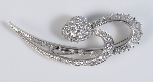 Platinum Brooch in a Double Swirl with a Pear Shape Pave 
strawberry shaped finial
there are 32 baguette cut diamonds on outside swirl, the "strawberr