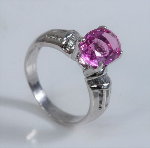 18 Karat White Gold Ring 
with oval pink sapphire, flanked by trillion cut, and round cut diamonds
size 6
sapphire 9.9 x 7.4 millimeters