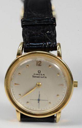 Omega Tiffany & Company 14 Karat Gold Men's Wristwatch
with leather Omega band, and 14 karat gold, monogrammed on reverse, Alan from Mother and Dad, Y