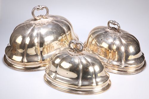 ^ A GRADUATED SET OF THREE SILVER-PLATED MEAT COVERS, of lo