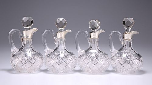 A SET OF FOUR GEORGE V SILVER-MOUNTED CUT-GLASS SPIRIT DECA