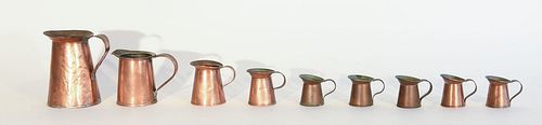 Nine Tin Lined Copper Pitchers