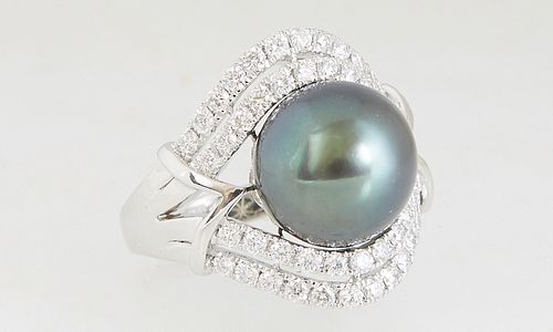 Lady's Platinum Dinner Ring, with a 12 mm dark grey cultured Tahitian pearl, flanked by a double graduated pierced diamond border on both sides, total