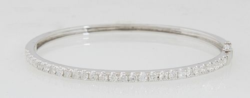 Lady's 14K White Gold Hinged Bangle Bracelet, one half mounted with 28 prong set round diamonds, total diamond weight- 1.93 cts., H.- 2 in., W.- 2 1/4