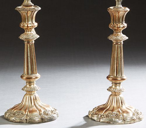 Pair of Silverplated Copper Candlesticks, early 20th c., with knopped and reeded supports, to a weighted scalloped sloping relief decorated base, now 