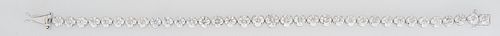 Lady's Platinum Tennis Bracelet, each of the 35 links with graduated round diamonds, total diamond weight- 11.44 cts., L.- 7 1/4 in., with appraisal.