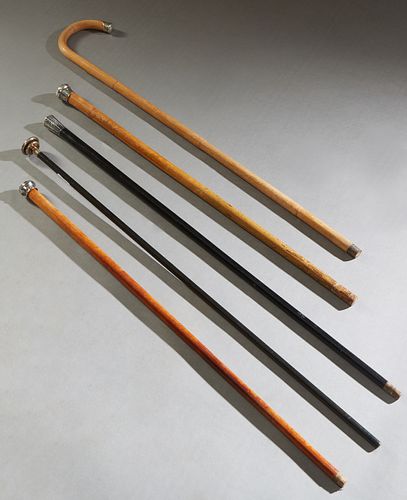 Group of Five Silver Mounted Walking Sticks, early 20th c., consisting of a tapered cylindrical example with a hammered sterling handle; a tapered map