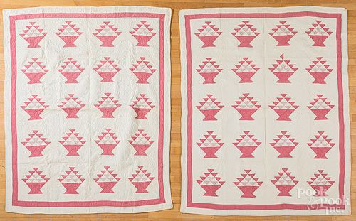 Pair of pink and white basket quilts