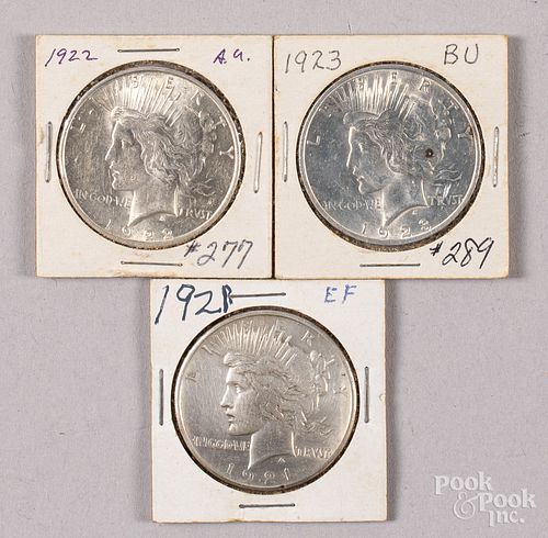 Three Peace silver dollars.