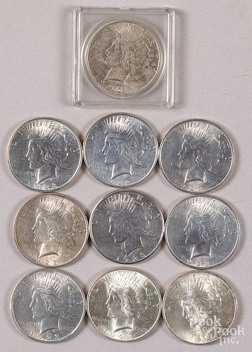Ten Peace silver dollars.