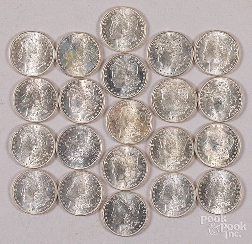Twenty-one Morgan silver dollars.
