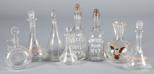 Eight colorless glass decanters and liquor bottle