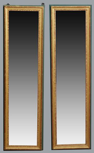 Pair of Tall Louis XVI Style Gilt Mirrors, 20th c., the beaded frames, mounted on polychromed backing boards, H.- 51 in., W.- 13 3/4 in., D.- 1 1/4 in
