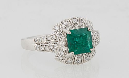 Lady's Platinum Dinner Ring, with a square 2.27 carat emerald atop a curved border of round diamonds, the tapered shoulders of the band also mounted w
