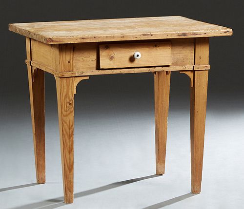 Louisiana Carved Pine Kitchen Table, c. 1900, the rectangular top over a wide skirt with a frieze drawer, on tapered square legs with curved bracket s