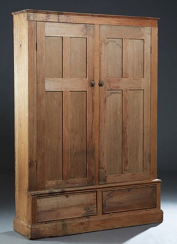 Large Louisiana Carved Pine Bookcase, late 19th c., the rounded edge crown over double paneled doors on a base with two fall front storage areas, on a