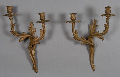 Pair of Louis XV Style Bronze Two Light Sconces, early 20th c., the leaf form back plate issuing two swirled leaf form arms with relief candle cups an