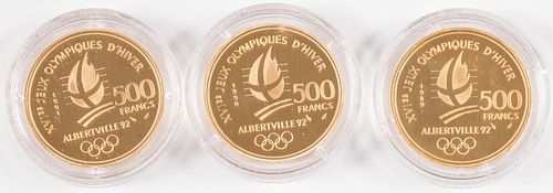 Three Albertville 500 Franc gold coins.