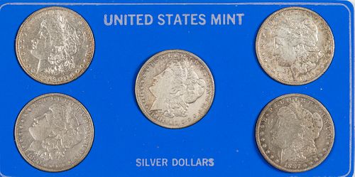Five Morgan silver dollars.