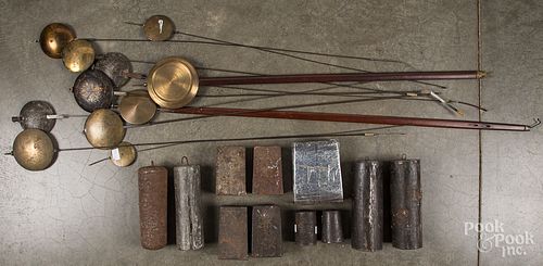 Antique clock weights and pendulums.