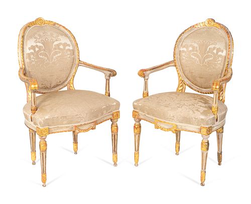 A Pair of Italian Neoclassical Painted and Parcel Gilt Armchairs
Height 39 inches.