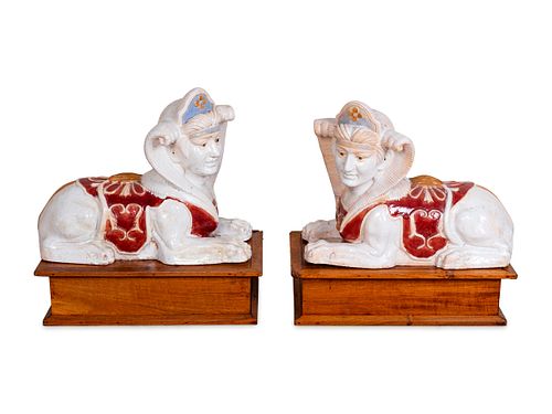 A Pair of Polychromed Ceramic Sphinxes
Height 19 x length 24 x width 11 inches; height of stands 8 x length 24 x width 14 inches.
