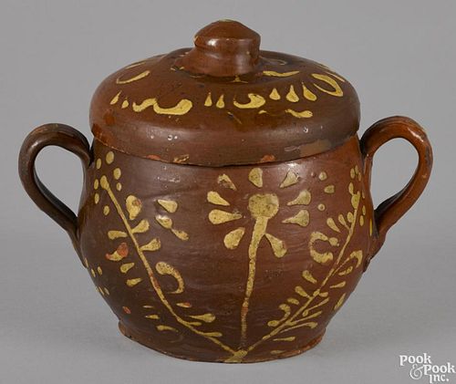 Redware covered sugar, 19th c., with yellow slip floral decoration, 6'' h.