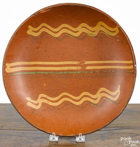 Pennsylvania redware charger, 19th c., with yellow and green slip decoration, 11 1/4'' dia.