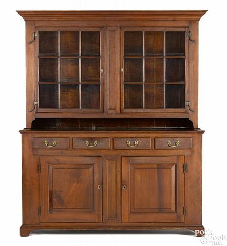 Pennsylvania walnut two-part wall cupboard, ca. 1800, the upper section with glazed doors