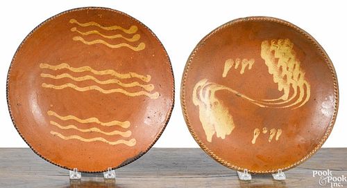 Two Pennsylvania redware chargers, 19th c., with yellow slip decoration, 10 1/2'' dia. and 11'' dia.