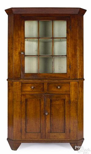 Western Pennsylvania tiger maple two-part corner cupboard, early 19th c., 84'' h., 45 1/2'' w.