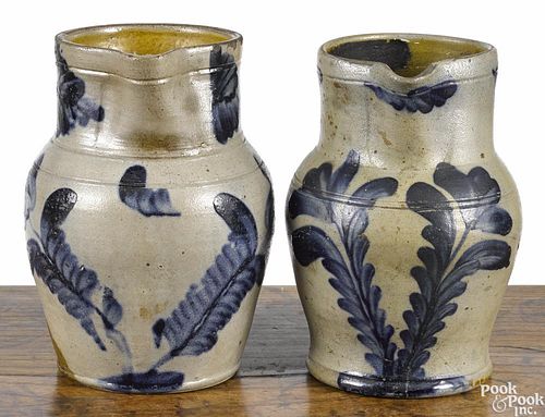Two Pennsylvania Remmey-type stoneware pitchers, 19th c., with cobalt floral decoration, 9'' h.