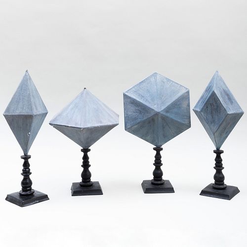 Group of Four Faux Painted Paper MÃ¢chÃ© Faceted Geometric Shapes on Ebonized Stands
