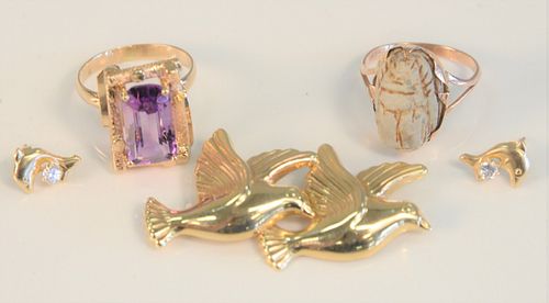 Four Piece Gold Lot
to include amethyst ring, scarab ring, bird brooch, and dolphin earrings
13 grams total weight