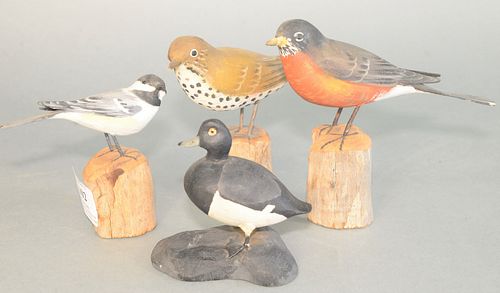 Group of four carved birds on wooden stands, three signed by Peter Pelte, along with one signed, 'Lacey'
ranging heights from 5 inches to 3 1/2 inches