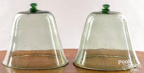 Two light green glass bell jars