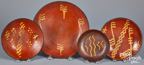 Four Pennsylvania slip decorated redware plates