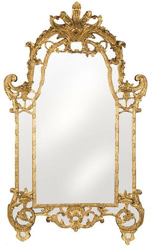 A MONUMENTAL CONTINENTAL CARVED GILTWOOD MIRROR