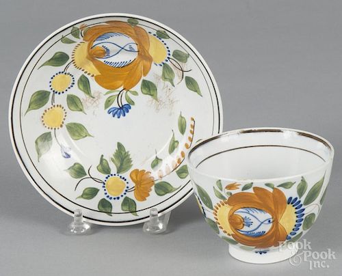 Leeds pearlware cup and saucer, 19th c., with floral decoration.