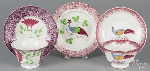 Two red spatterware peafowl cups and saucers, 19th c., in a peafowl and cockscomb pattern