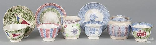 Nine pieces of spatterware porcelain, 19th c., to include a blue and purple rainbow sugar bowl, cups