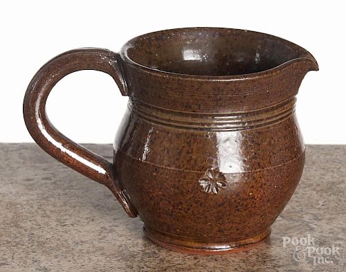 R. R. Stahl redware cream pitcher, signed and dated 1953, with a floral stamp around the waist