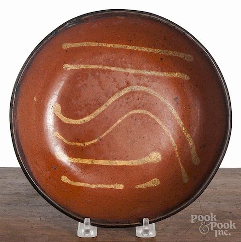 Pennsylvania slip decorated redware shallow bowl, 19th c., 8 1/2'' dia.