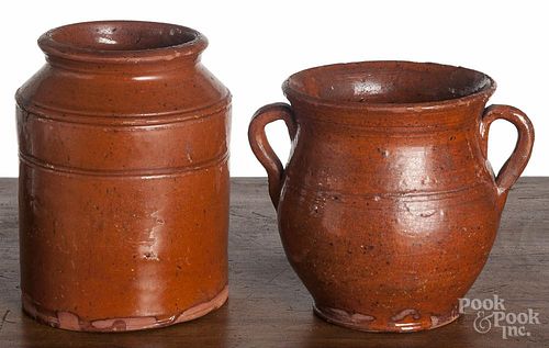 Two pieces of Pennsylvania redware, 19th c., to include a jar and a handled vase, 6'' h. and 5'' h.
