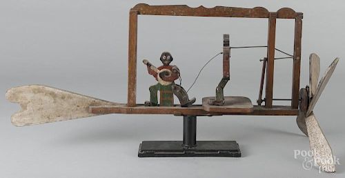 Painted black Americana whirligig, early 20th c., with a banjo player and a dancer, 37 1/2'' l.