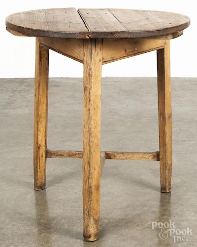 Pine tavern table, late 18th c., with a stretcher base, 26'' h., 24'' dia.