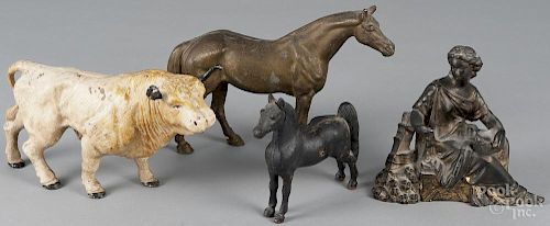 Cast iron bull bank, 20th c., together with a cast iron horse bank, a spelter horse figure