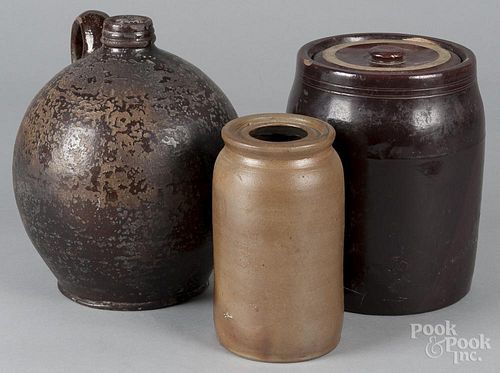 Three pieces of stoneware, 19th c., to include a redware ovoid jug, 10'' h., a canning jar, 7 1/4'' h.